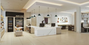 Un hall d’hôtel moderne avec un comptoir d’accueil, un minibar et un espace salon.
