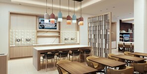 A modern hotel lobby with a central bar area, seating arrangements, and a television displaying the weather. - Homewood Suites By Hilton Shreveport South (Shreveport)