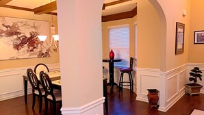 A dining area with a table and chairs, a vase, and a potted plant. - Welcome to Mr. T's Palace!
Stay big. Relax easy. 
Your Home away from Home. (Jonesboro)