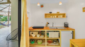 A compact kitchen with a wooden countertop, a sink, and a coffee maker. - Jungle Studio -Steps to Beach-Wi Fi -AC-Work-Surf (Santa Teresa)