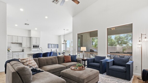 A spacious living area with a sectional sofa, a coffee table, and a dining area with a table and chairs. - Greyhawk Golf Escape w/ 5-Bedrooms, Heated Pool, Spa & Putting Green (Scottsdale)