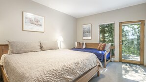 A bedroom with a large bed, a smaller bed, a window, and a door leading to a balcony. - Savoy Villas 4D, 3BD Vail Condo With Garage (Vail)