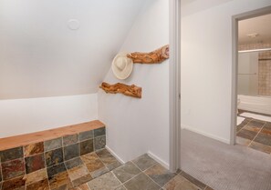 A hallway with a bench, a wall-mounted hat, and a wooden piece. - Gore Circle Chalet, 4BD Private East Vail Home (Vail)