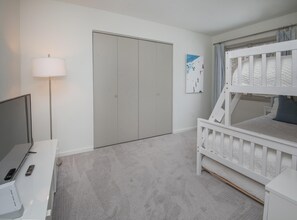 A child's bedroom with a bunk bed, a desk with a computer, a lamp, and a wardrobe. - Gore Circle Chalet, 4BD 3BA Private East Vail Home (Vail)