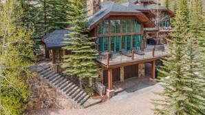 A multi-story log cabin with a deck, stone staircase, and large windows. - 796a Potato Patch - 4BD Private Home in Vail (Vail)