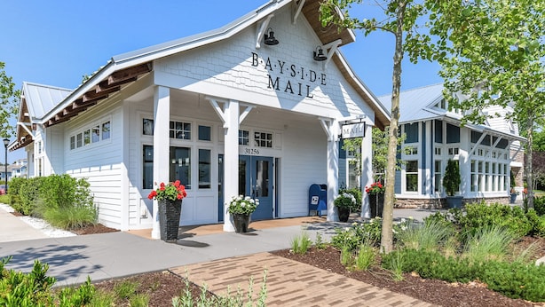 A Bayside Mail post office with a white exterior, large windows, and a covered entrance area. - Bayside Resort Escape: 5BR Coastal Home -Golf, Pools, Restaurants & Beach Access (Selbyville)