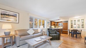 A modern living room with a sofa, coffee table, and a dining area with a table and chairs. - Westwind 209 1bd, 1BA Platinum Condo in Lionshead Village (Vail)