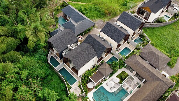A resort with multiple buildings, swimming pools, and lush greenery. - Bintang Villas Ubud (Ubud)