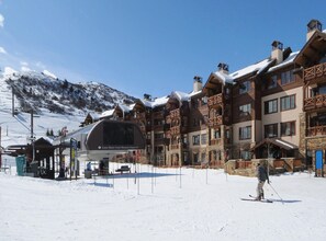 A ski resort with a mountain backdrop, wooden buildings, and a ski lift. - Beaver Creek Landing A204, 3BD 3.5ba Ski In/out Condo (Avon)