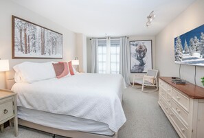 A bedroom with a bed, bedside tables, a dresser, a chair, and artwork on the walls. - Ascent 301, 3BD Condo in Avon With Amenities (Avon)