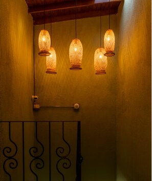 A wall with three hanging lamps and a metal gate with a decorative design. - Modern Private Suite Terrace + Self Check-in (Medellín)