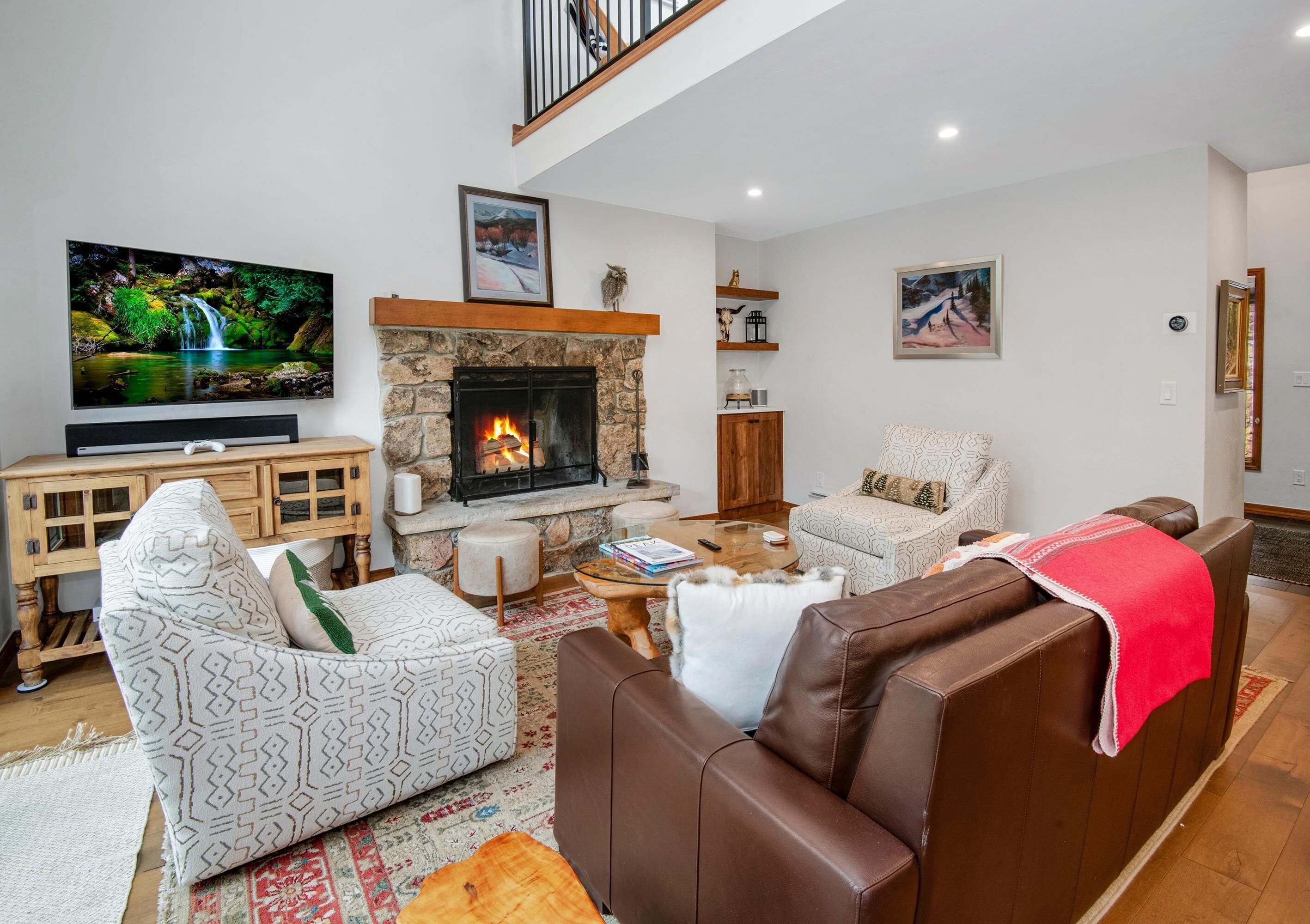 A living room with a fireplace, a television, and a sofa.