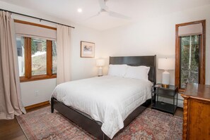 A bedroom with a bed, bedside lamps, a nightstand, a mirror, and a window with curtains. - Timber Falls 304, 3BD East Vail Condo With Amenities (Vail)