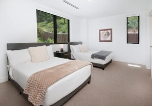 A bedroom with two beds, a nightstand, a lamp, and a framed picture on the wall. - Frontgate 305, 3 BD Condo in Avon With Amenities (Avon)
