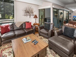 A modern living room with a sofa, armchairs, a coffee table, and a decorative wall piece. - Vail International 111, 2 BD Lionshead Village Condo (Vail)