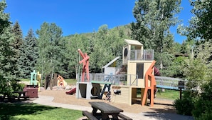A playground with slides, climbing structures, and picnic tables. - Sun Vail 12e, 2BD Condo With Vail Mountain Views (Vail)