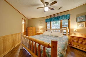 A bedroom with a wooden bed, a ceiling fan, a dresser, and a window with curtains. - Sky Valley Views! Deck, Golf, 2 Kings (Dillard)