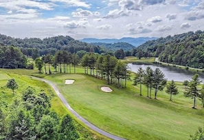 A golf course with a lake, surrounded by trees and hills. - Sky Valley Views! Deck, Golf, 2 Kings (Dillard)