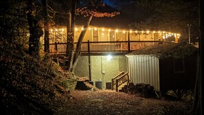A house with a wooden deck, string lights, and a covered entryway. - Sky Valley Views! Deck, Golf, 2 Kings (Dillard)