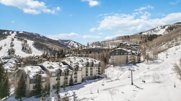 A ski resort with multi-story buildings, ski lifts, and snow-covered slopes.