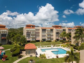 A hotel with multiple buildings, a swimming pool, and a playground. - Caribbean Ocean View 3-BR Villa with Panoramic Ocean Views & 2 Private Terraces (Humacao)