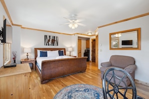 A bedroom with a bed, bedside tables, a chair, a ceiling fan, and a TV. - Borders Lodge L406 3BD Beaver Creek Ski-in, Ski-out Condo (Avon)
