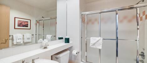A bathroom with a bathtub, toilet, and shower.