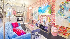 A modern living room with a sofa, coffee table, and artwork on the walls. - II. Chic 4BR Home by Universal + Patio + Grill + Parking (Los Angeles)