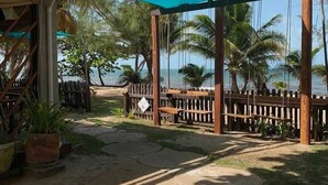 Un gazebo in legno con un tetto blu, una recinzione di legno e vista sull'oceano.