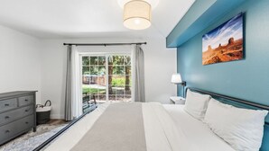A bedroom with a bed, a dresser, a nightstand, a lamp, and a painting on the wall. - Alpine Escape | Pool, Hot Tub & Mountain Access (Edwards)
