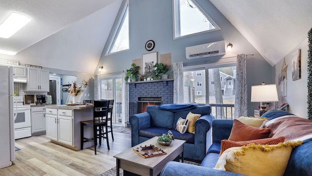 Een moderne loft met keuken, woongedeelte en een open haard.