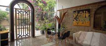 House with garden in front of the Pyramid of Cholula, Puebla,MX