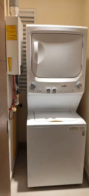 A compact washer and dryer unit with control knobs and a visible brand name. - Santa Akumalito (Tulum)