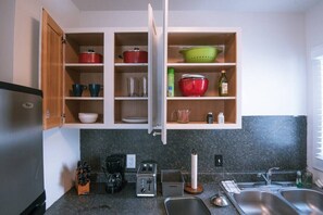 A kitchen with open cabinets, a coffee maker, a toaster, and a sink. - 1120 #A Salt Lake Duplex (Salt Lake City)