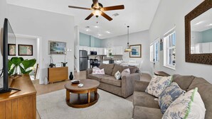 A modern living room with a sofa, coffee table, and ceiling fan. - Beachbound 2BR Apt 1282 (Jensen Beach)