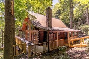 A cabin with a stone chimney, wooden deck, and a covered porch. - Bucks Cabin - Minutes From Downtown, pet Friendly (Boone)
