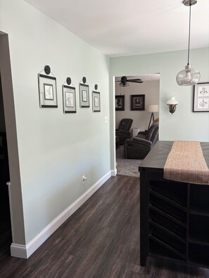 A dining area with a dark wood table, a bench, and a ceiling fan. - EAA Destination Home!  3 bedroom 2 1/2 bath and just 15 minutes from EAA! (Neenah)
