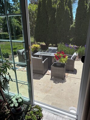 A patio with wicker furniture, a table with a fire pit, and potted plants. - EAA Destination Home!  3 bedroom 2 1/2 bath and just 15 minutes from EAA! (Neenah)