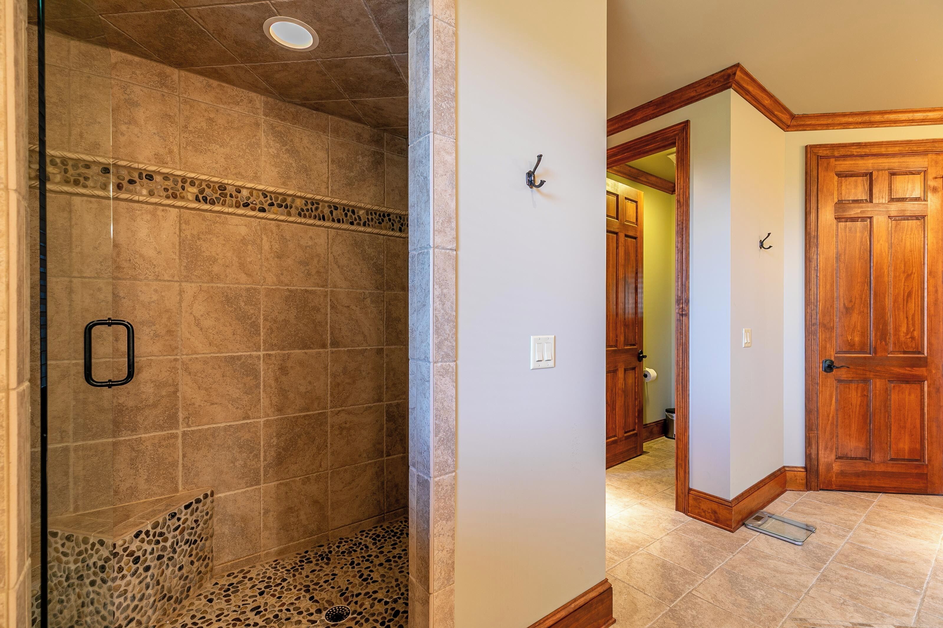 A bathroom with a shower, a toilet, and a sink.