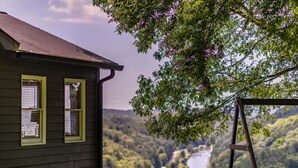 Een huis met een veranda en uitzicht op een rivier.