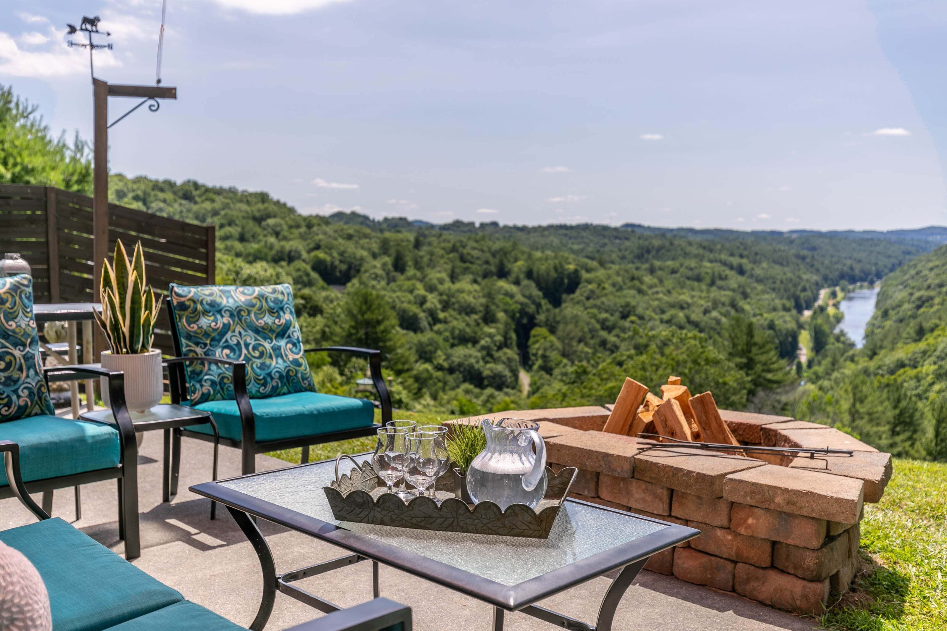 An outdoor seating area with a table, chairs, and a fire pit.