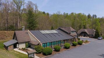 A lodge with a large building featuring a sloped roof and a smaller attached structure.