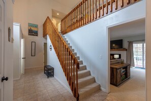 A staircase with wooden railings, a framed picture on the wall, and a carpeted floor. - Riverwood at Mill Ridge (Banner Elk)