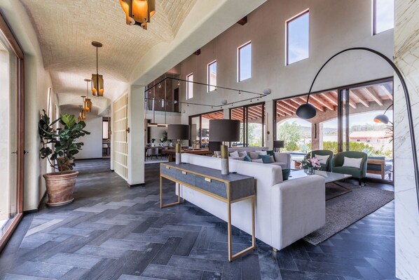 A spacious living area with a modern sofa, a coffee table, and a potted plant.