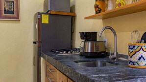 A kitchen with a refrigerator, stove, sink, and a coffee maker. - Verde Suite - Zona Romantica Suites (Puerto Vallarta)