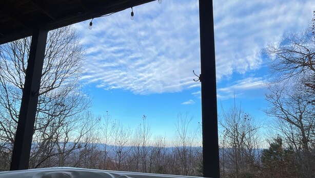 A hot tub with a view of a mountainous landscape through large windows. - Epic Mountain Views! Cool Weekend Retreat • Pet Friendly Near Charlette (Morganton)
