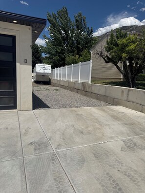 A concrete pathway leading to a building marked with a 'B'.