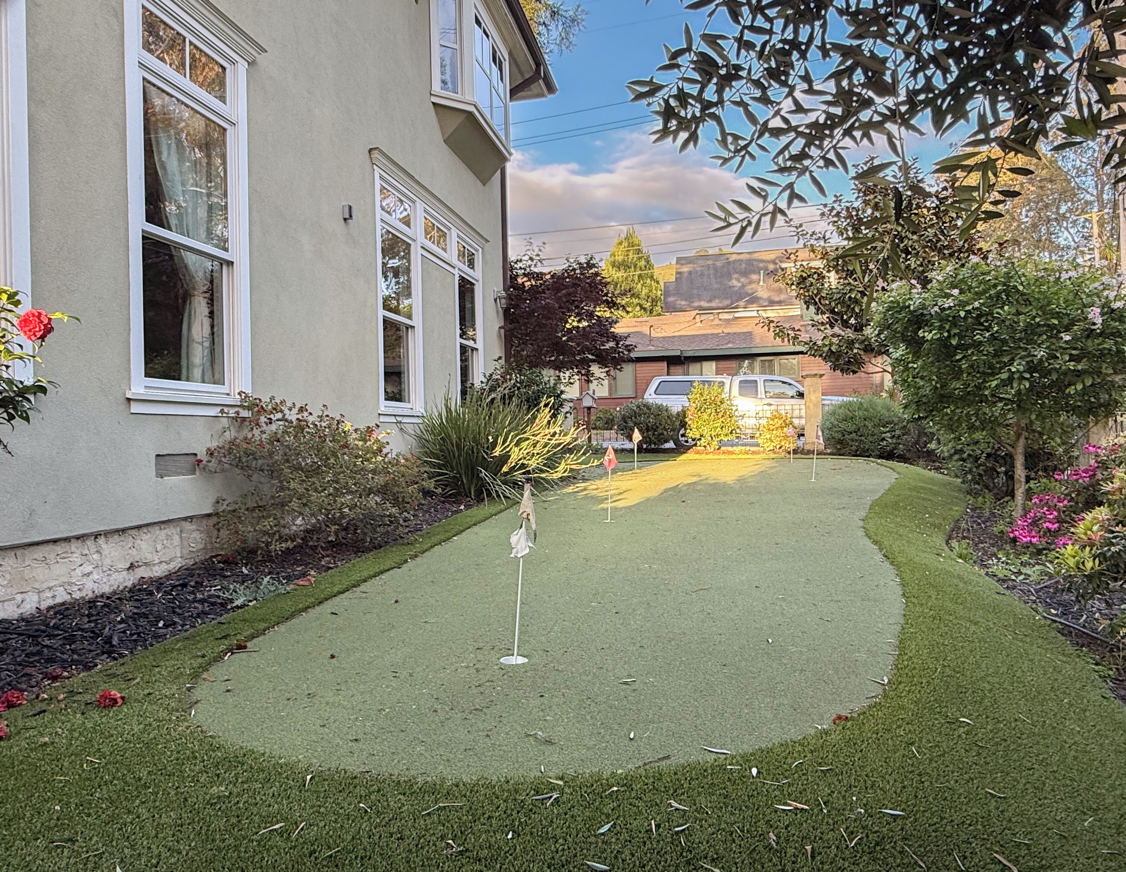 A residential property with a well-maintained lawn, a driveway, and a garage.