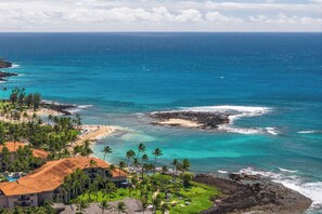 A coastal hotel with a view of the ocean, beach, and palm trees. - Kiahuna 183 Ground Floor Ocean View PBAC (Koloa)