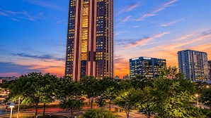 A high-rise building with a modern design, featuring multiple floors and a prominent vertical structure.